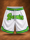 White basketball shorts with green and lime green trim, featuring the word 'Brownies' in green script across the front, shown against a brown textured background.